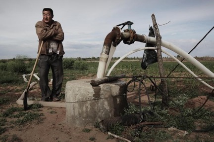 Farmer beside well in inner Mongolia